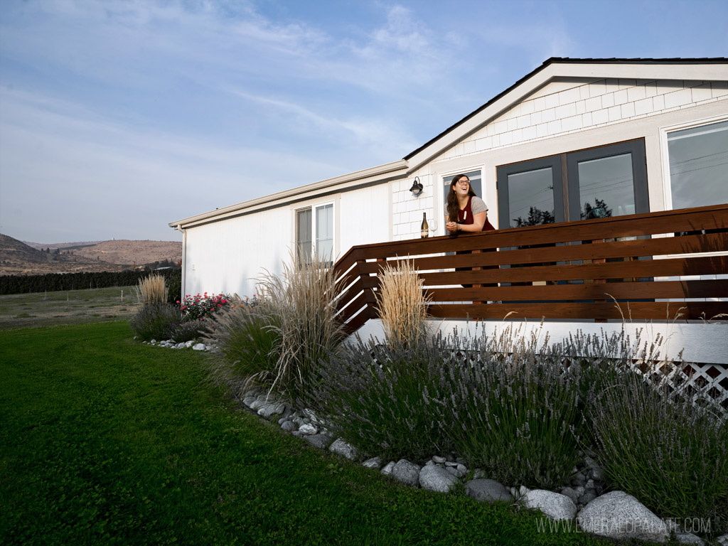 woman drinking wine on a deck of one on of the best places to stay in Lake Chelan