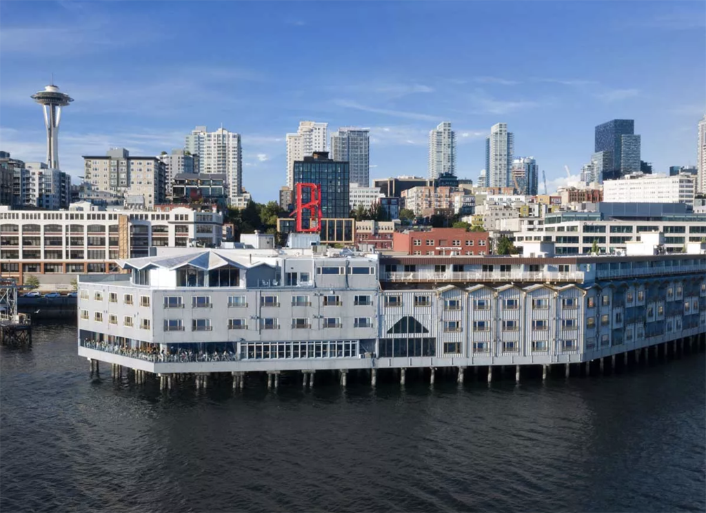Hotel on the water with Seattle skyline in the background