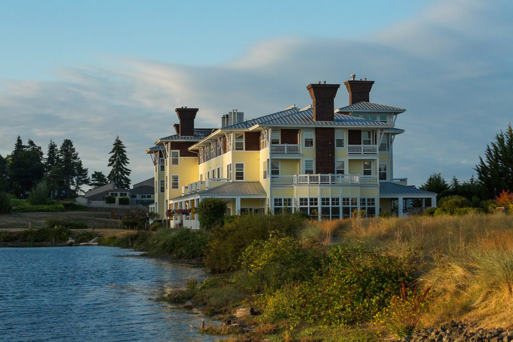 Exterior of a quaint hotel overlooking water