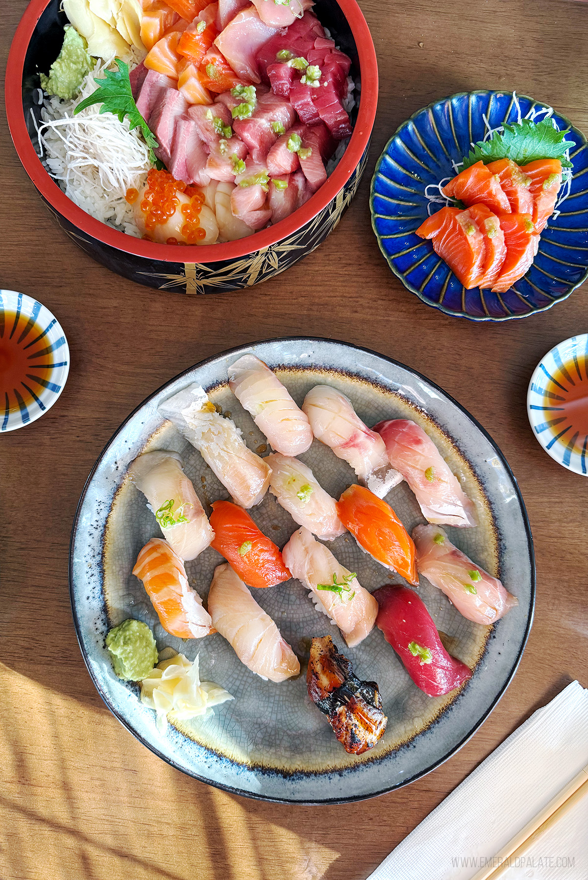 plate of nigiri sushi and sashimi don bowl