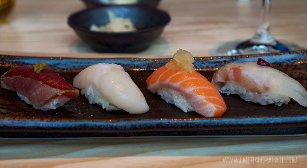 4 nigiri pieces lined up on a plate