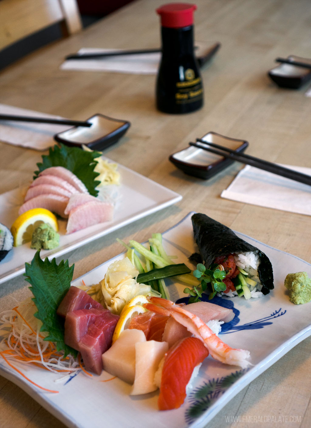 Two plates of sushi on the table of a Seattle sushi spot