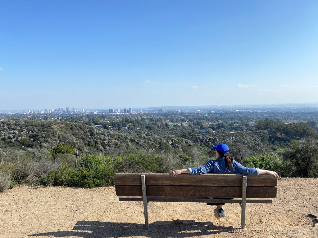 woman on a bench looking out at a viewpoint during a 4 day Los Angeles itinerary