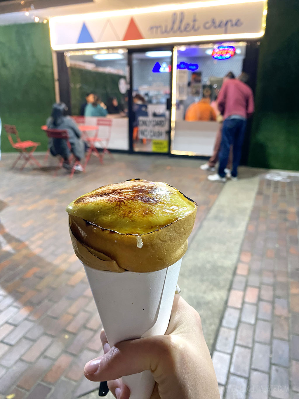 person holding a creme brulee crepe cone at a must visit restaurant on any 4 day Los Angeles itinerary