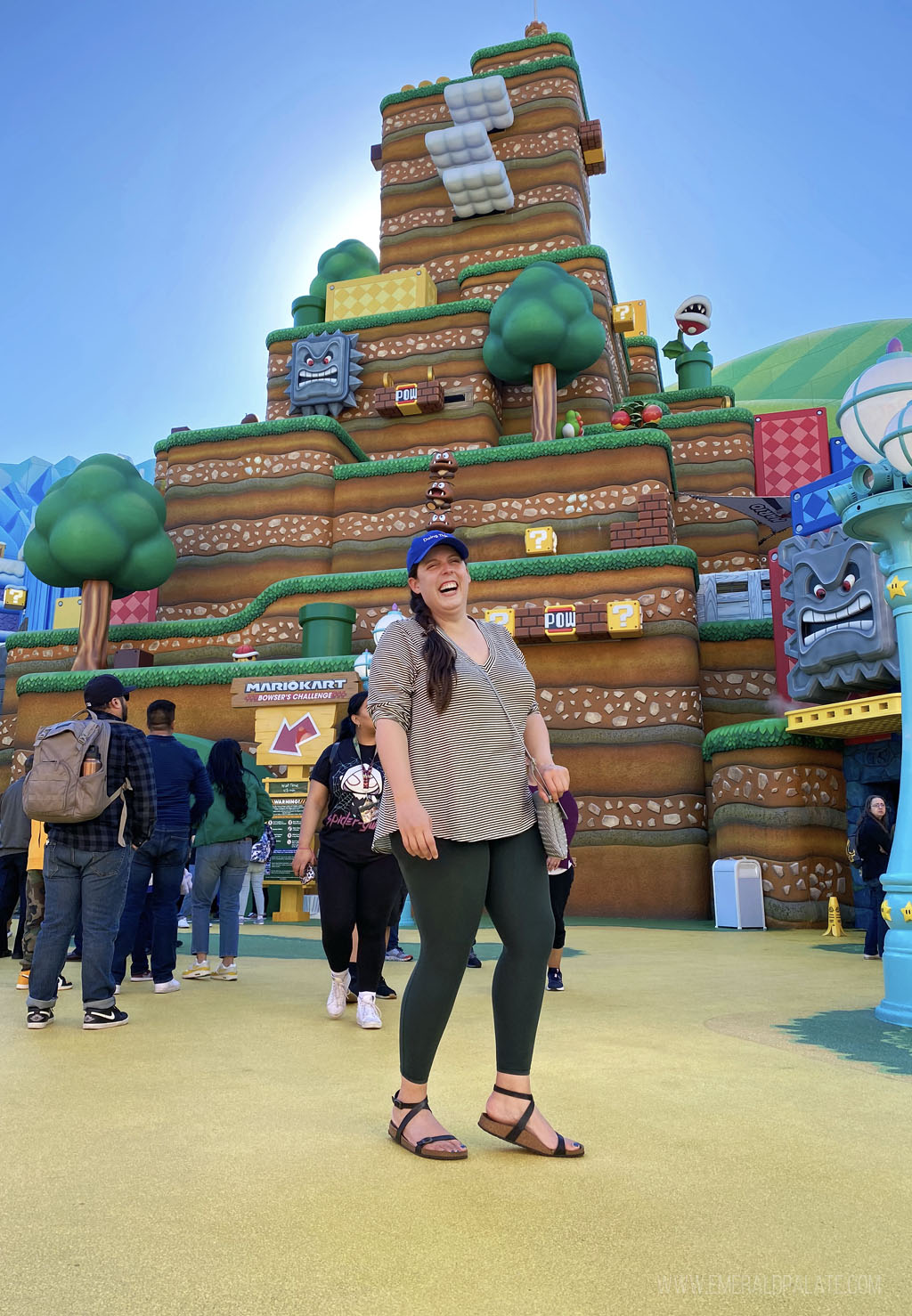 woman standing in front of the Super Nintendo World mountain at Universal Studios Hollywood