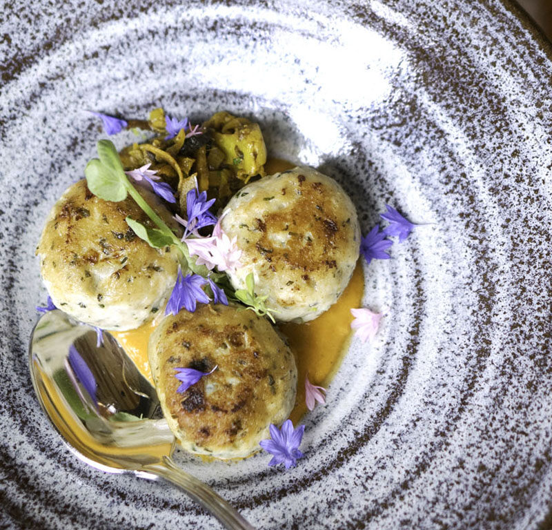 bowl of crab cakes from one of the farm-to-table restaurants in Seattle