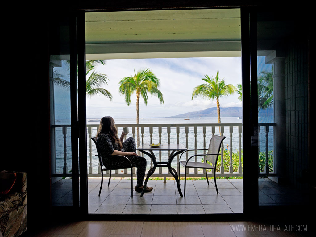 woman drinking coffee on a lanai - where to stay in Maui