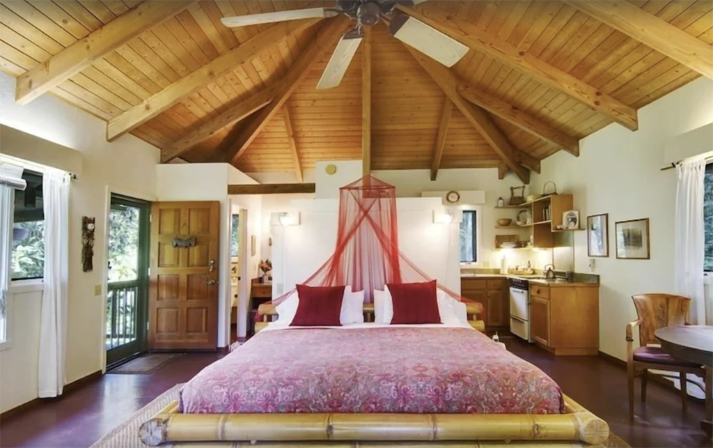 bamboo bed with mosquito net in a romantic place to stay in Maui