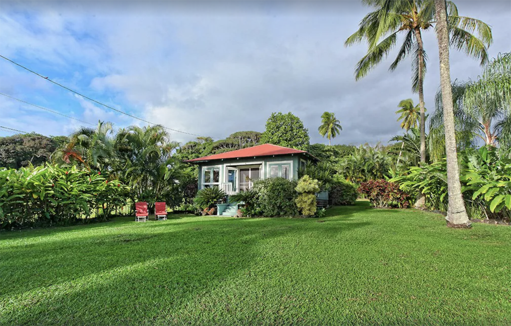 historic bungalow nestled between tropical trees