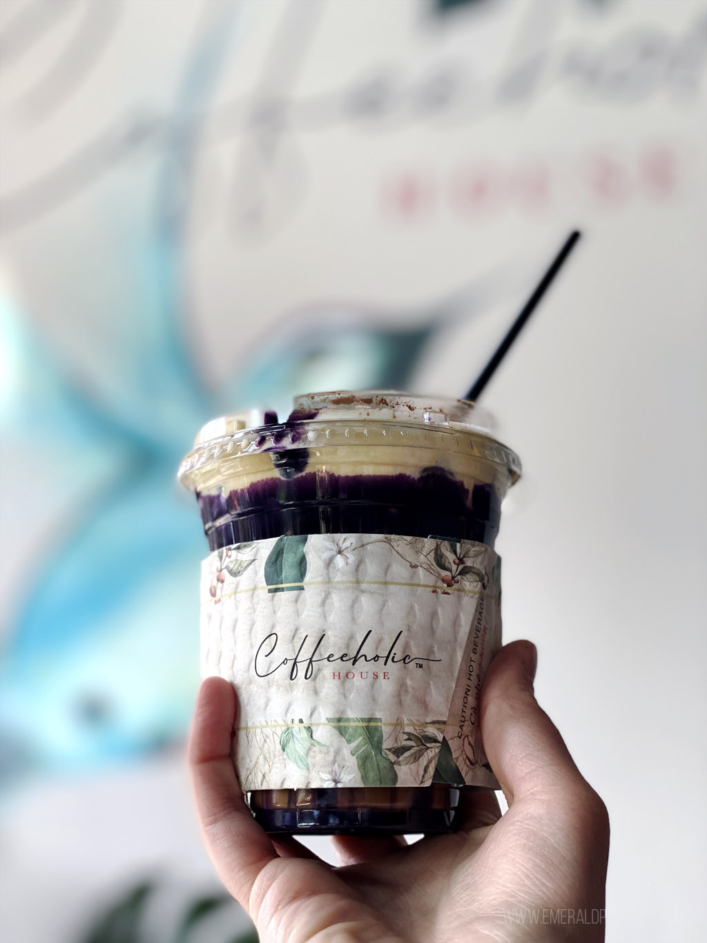 person holding a ube latte from a Seattle coffee shop