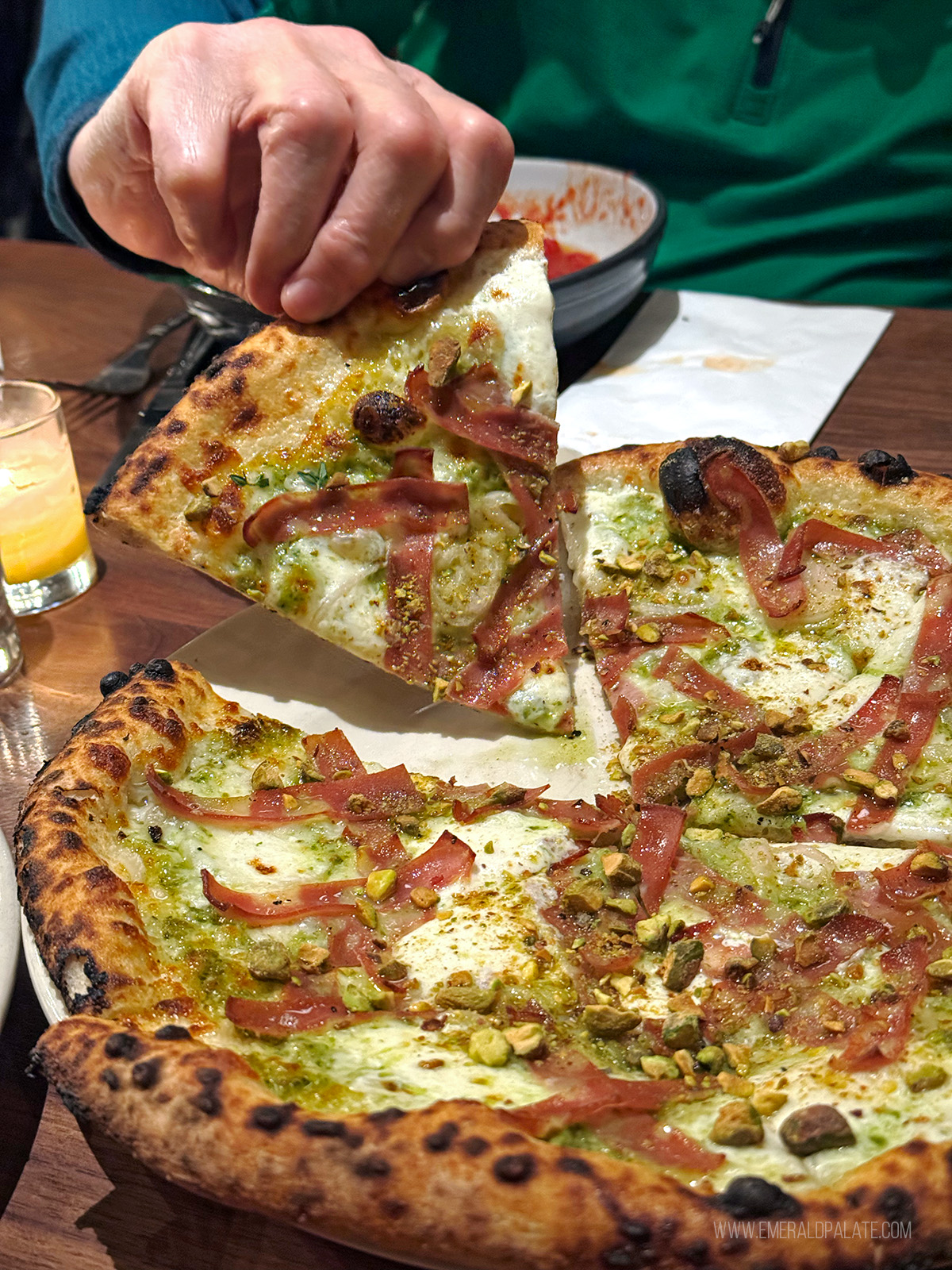 person picking up pizza from Kens Artisan Pizza in Bend Oregon