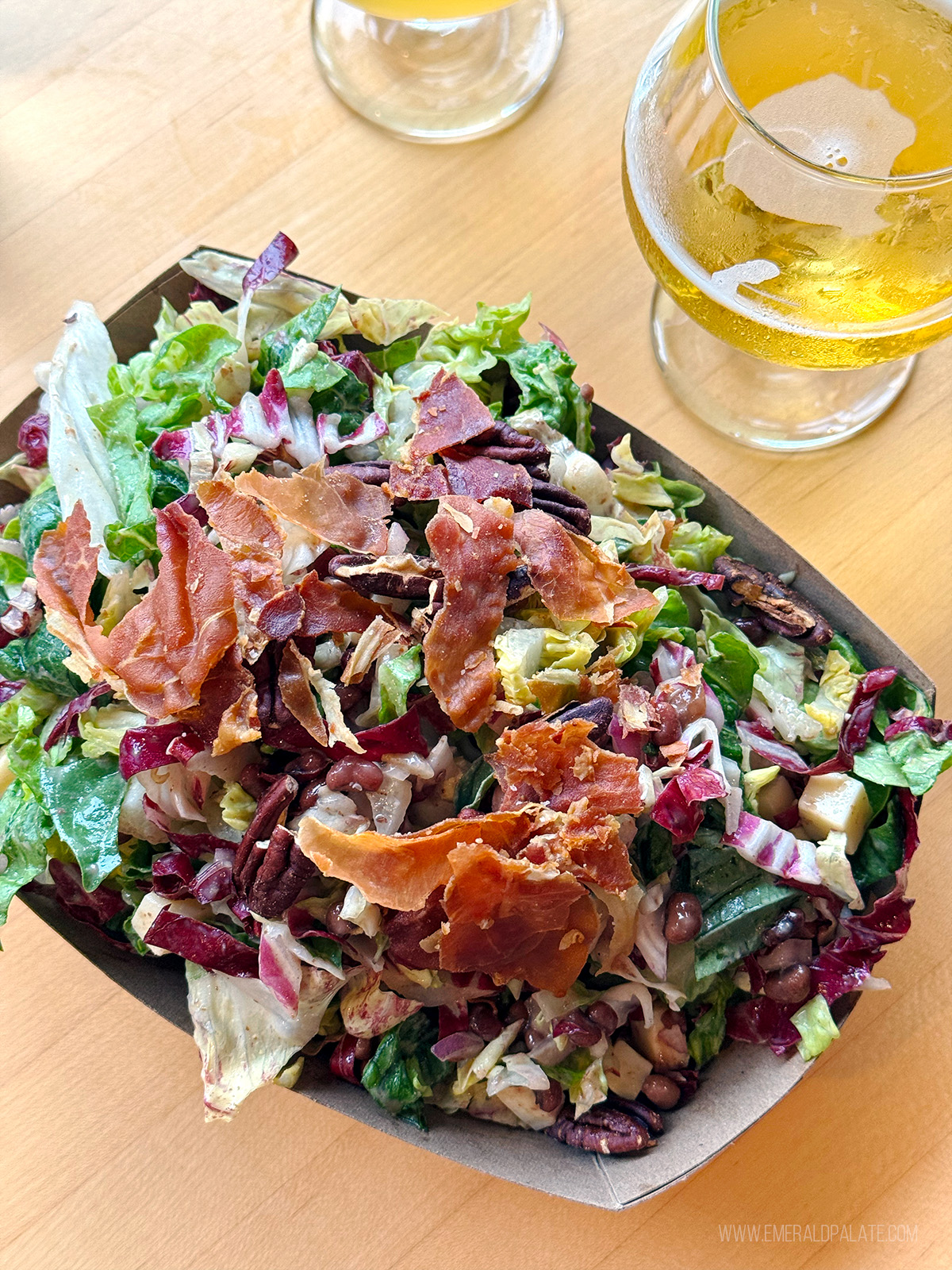 chopped salad topped with prosciutto, one of the best salads in Seattle