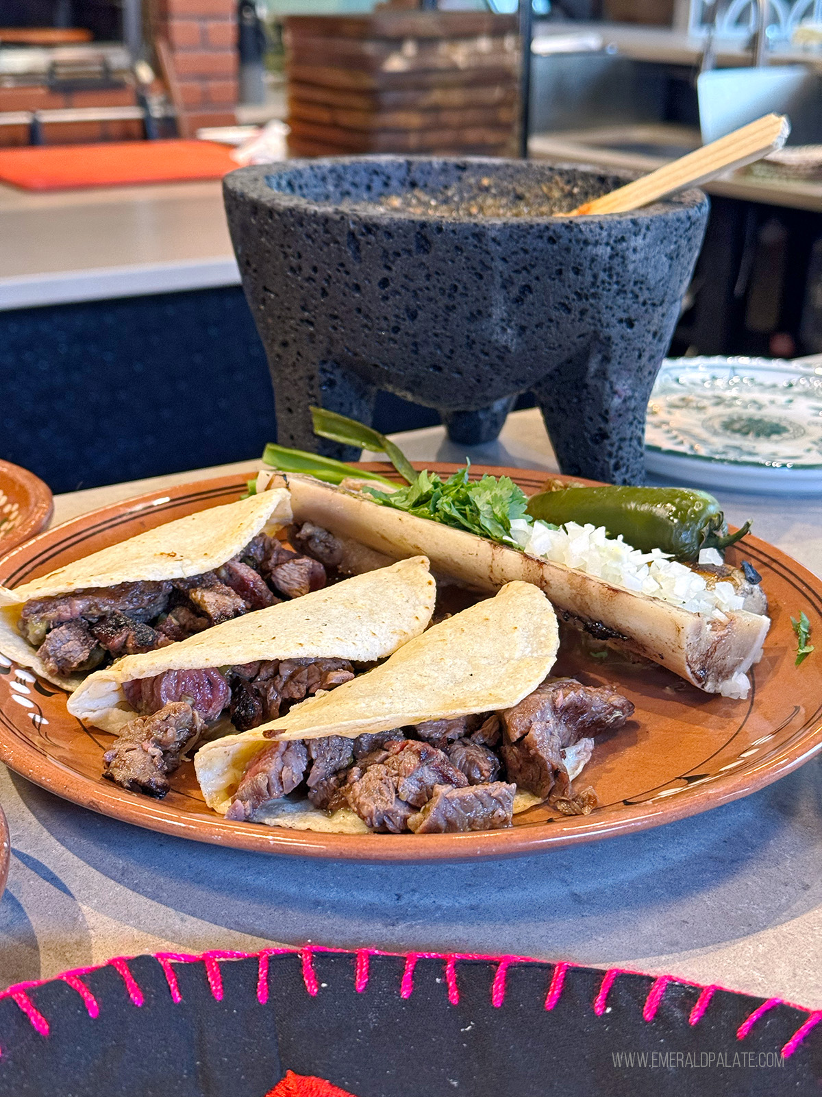 Steak tacos with salsa in a mortar and pestle