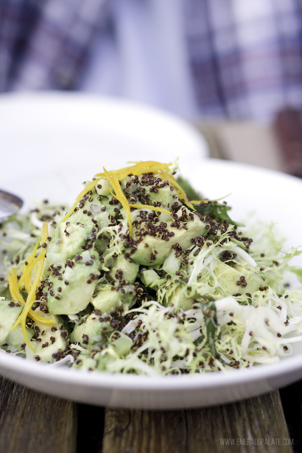 frisee salad with puffed quinoa, avocado, cucumbers, and orange zest