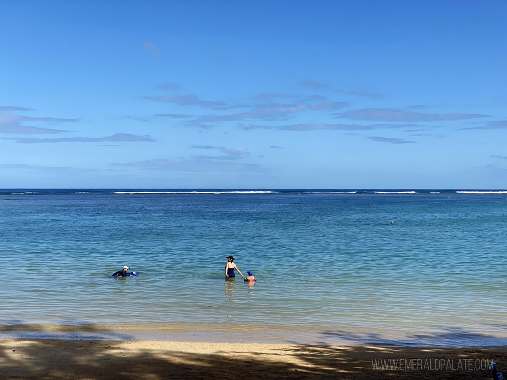 people swimming a Anini Beach, a must visit on your Kauai itinerary for snorkeling