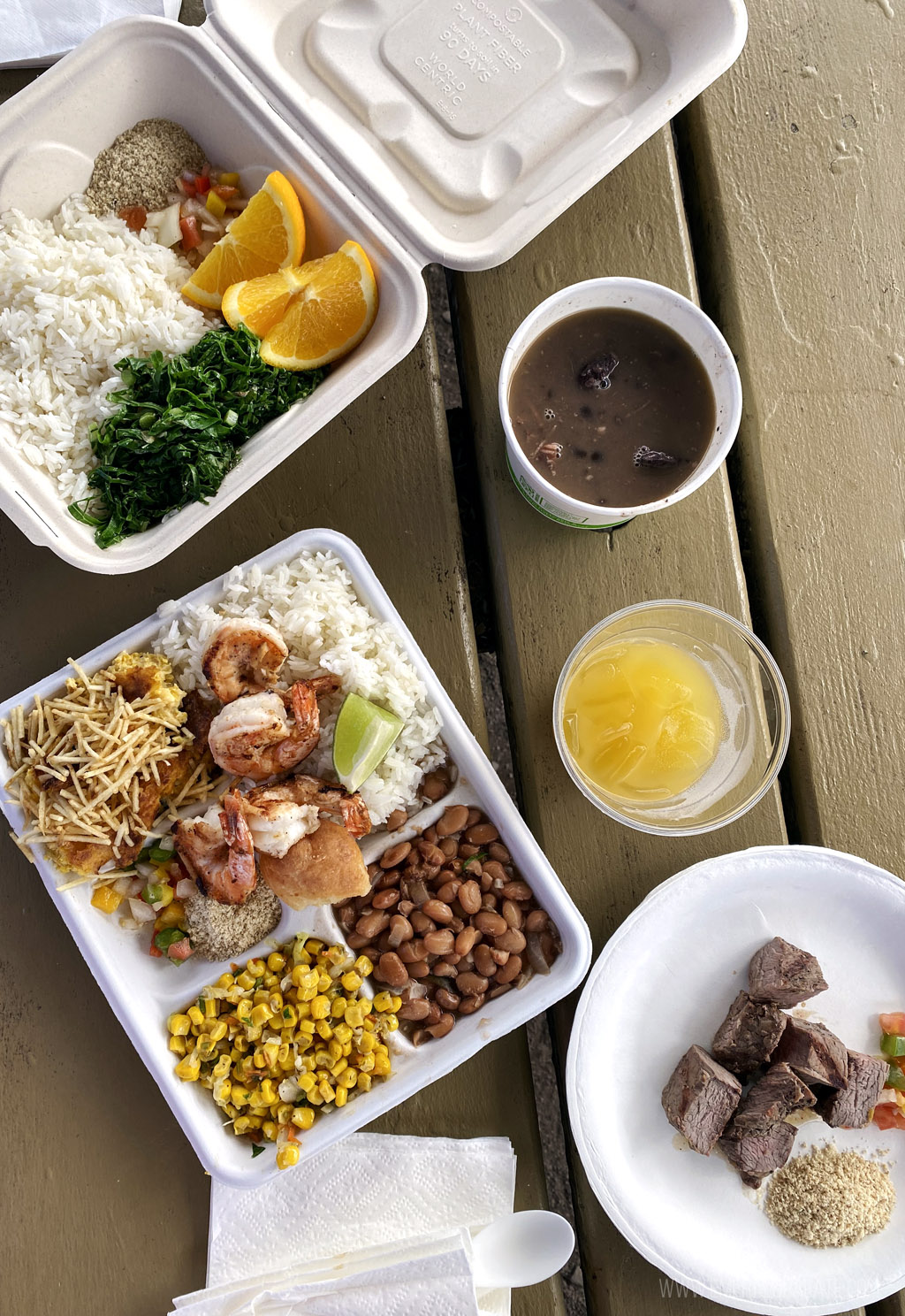 overhead shot of Brazilian food in takeout containers