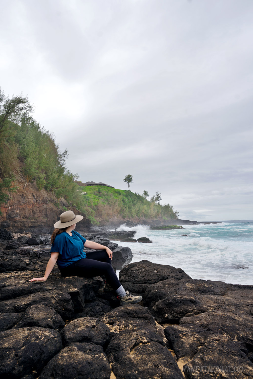 woman enjoying the view from Secret Beach on her Kauai itinerary