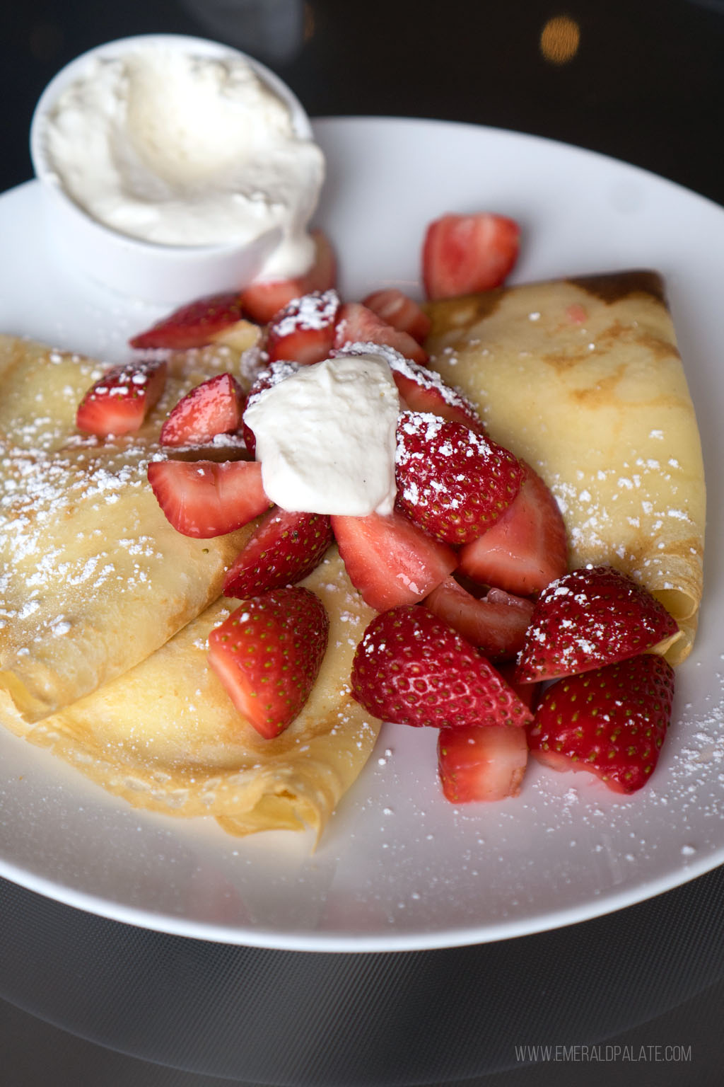 crepes topped with strawberries and whipped cream