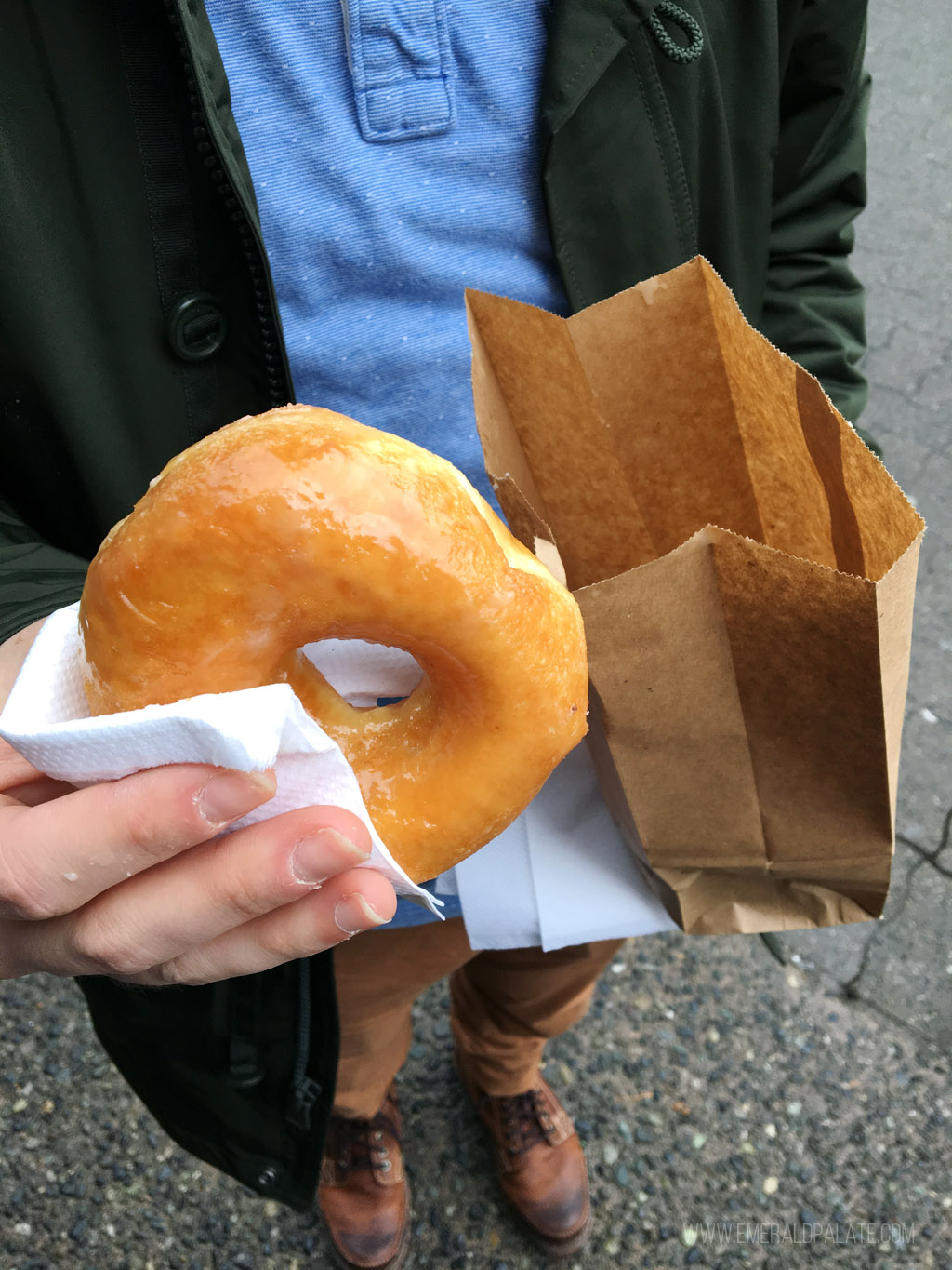 person holding a honey doughnut from a Vancouver restaurant
