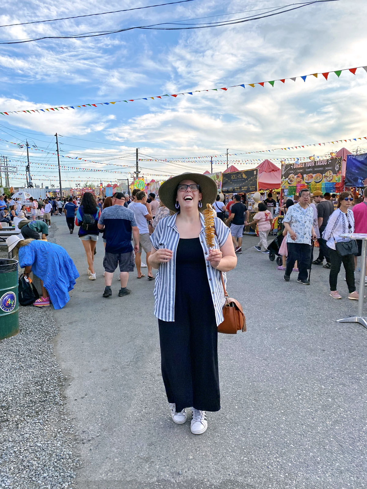 woman enjoying street food at an Asian nigh market during a travel guide to Vancouver BC