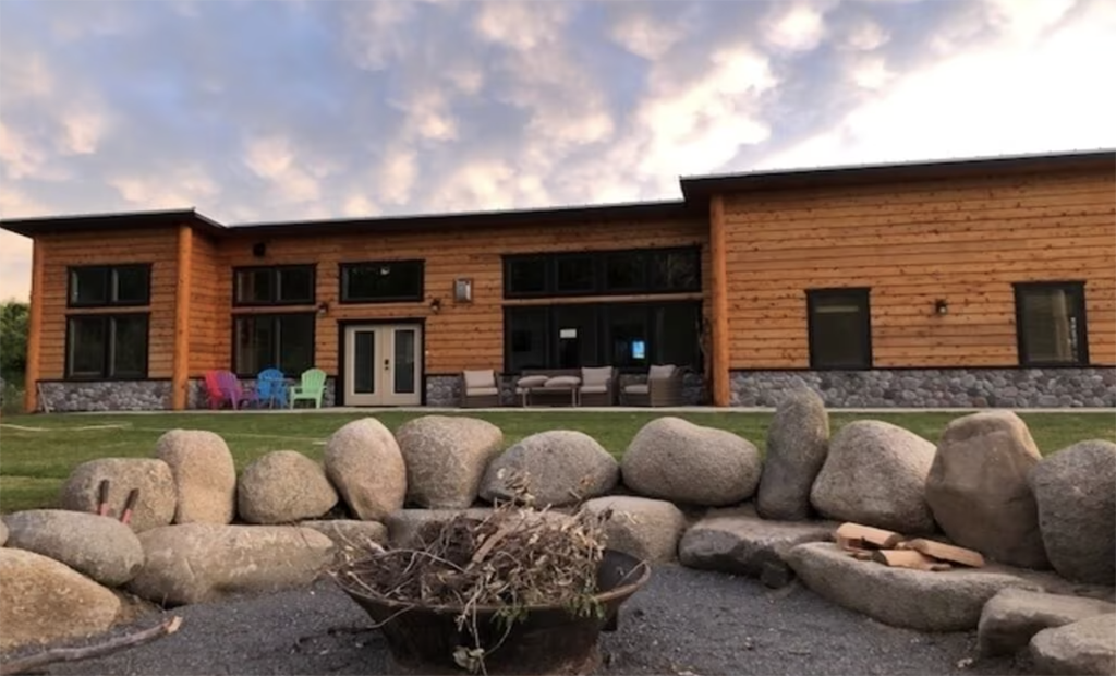 modern cabin with an outdoor stone firepit