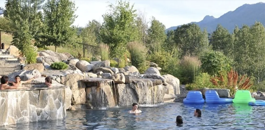 people enjoying a swim in a resort-like pool
