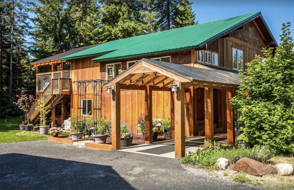 exterior of a cabin with a green roof