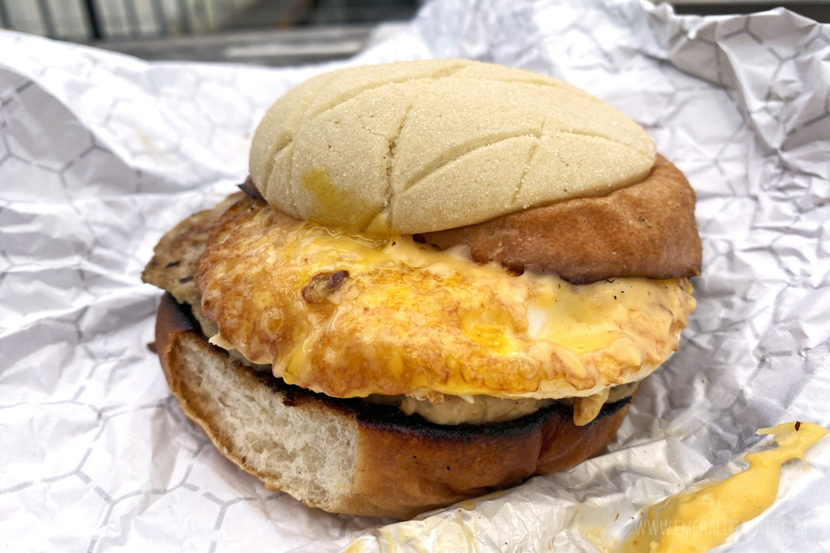 messy breakfast sandwich with egg, cheese, and sausage
