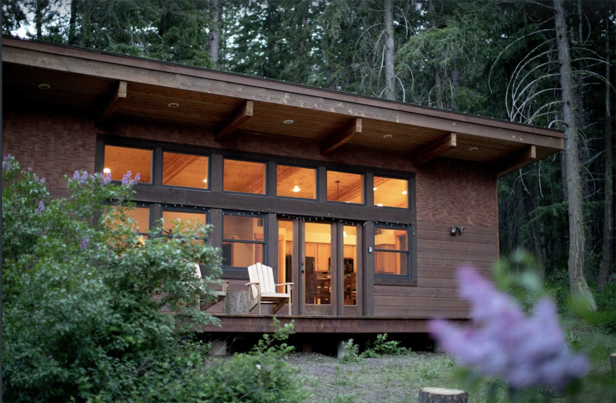 outside a modern cabin with a lot of windows