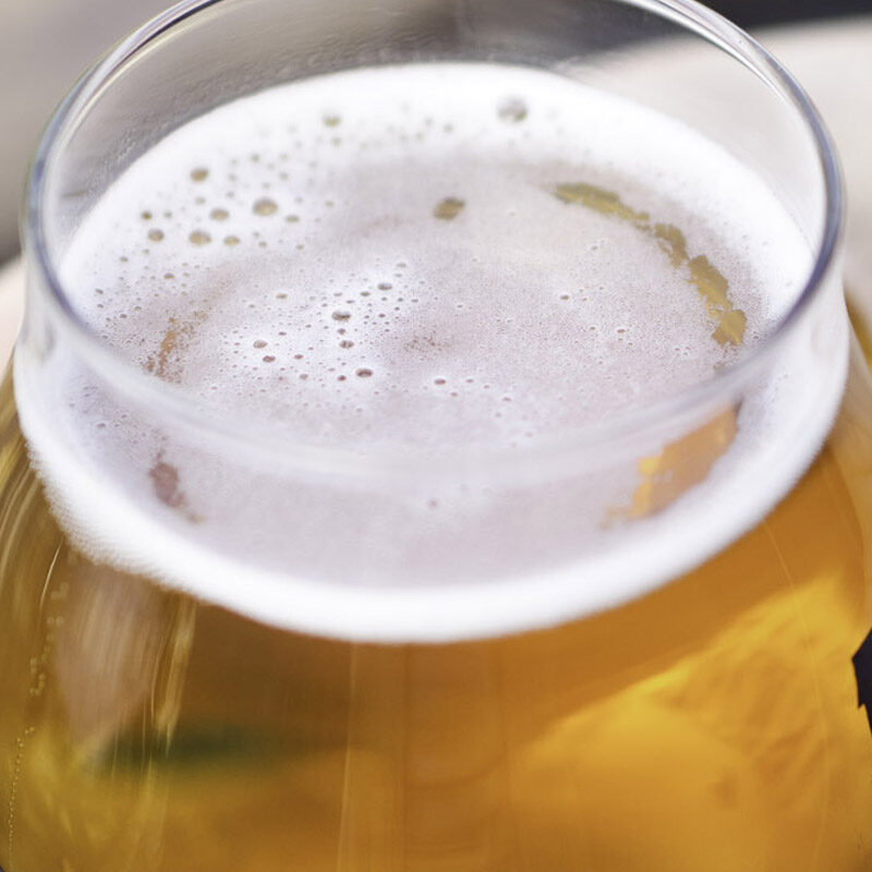 close up of person holding glass at one of the best craft beer bars in Seattle