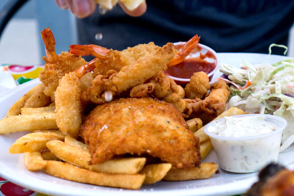 person squeezing lemon over the best fish and chips in Seattle