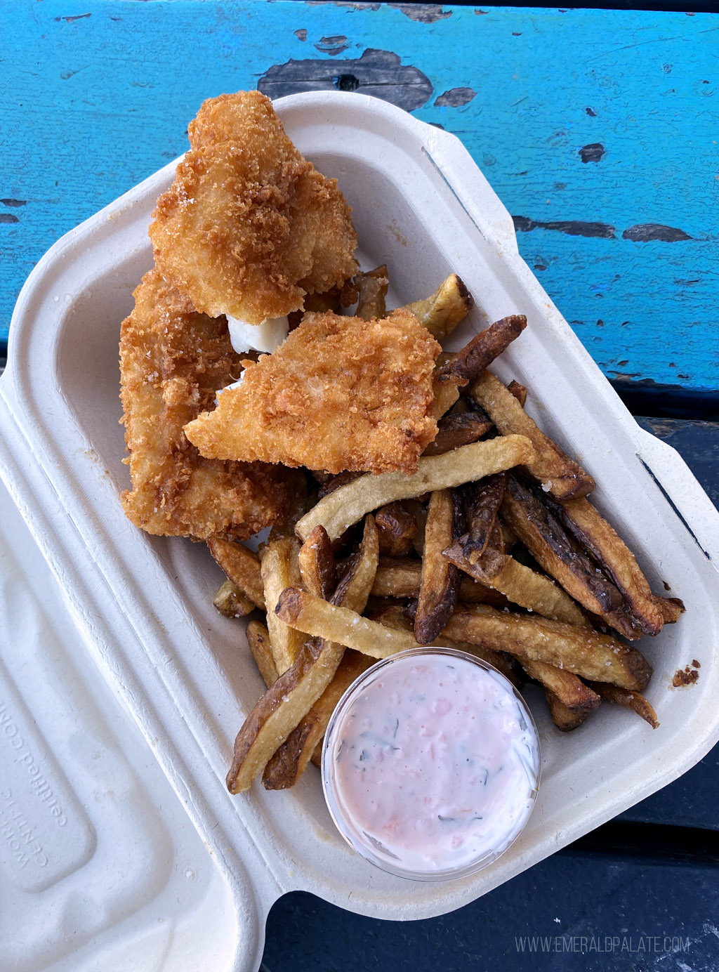 breaded fish and chips in a takeout container