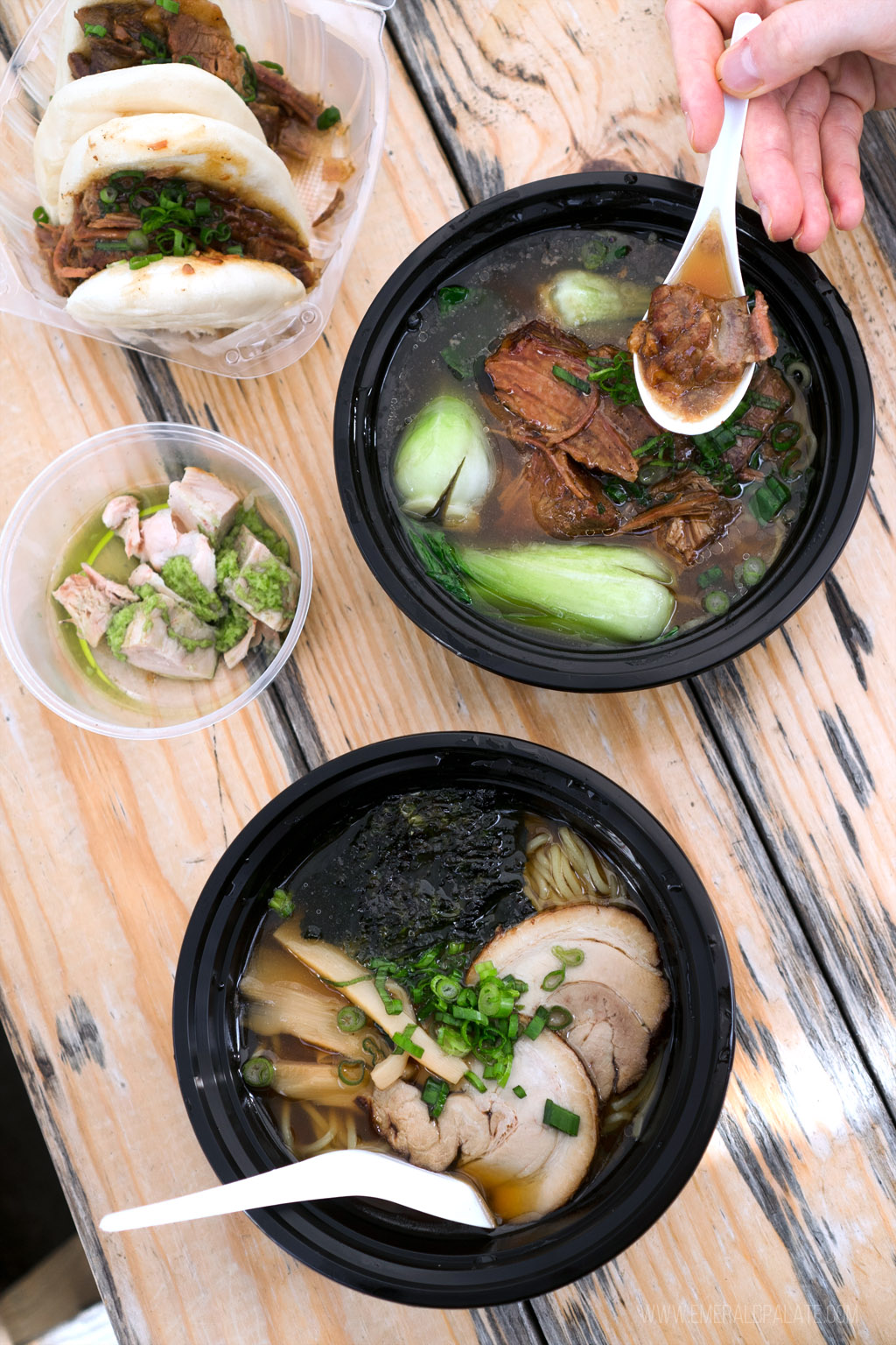 person picking up a spoonful of brisket ramen from a ramen spot in Seattle