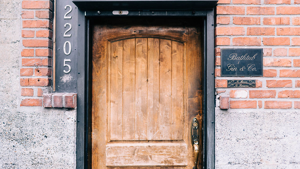 Wooden door at the entrance of a hidden bar in Seattle