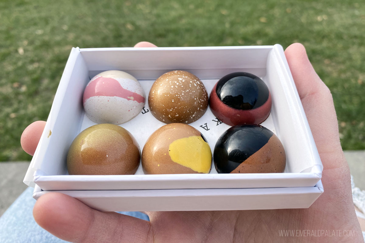 person holding a box of colorful bonbons