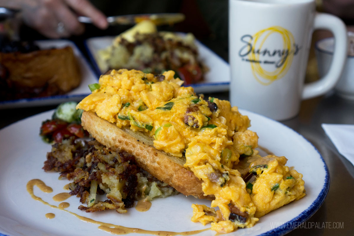 scrambled eggs cascading off a big piece of toast at a diner