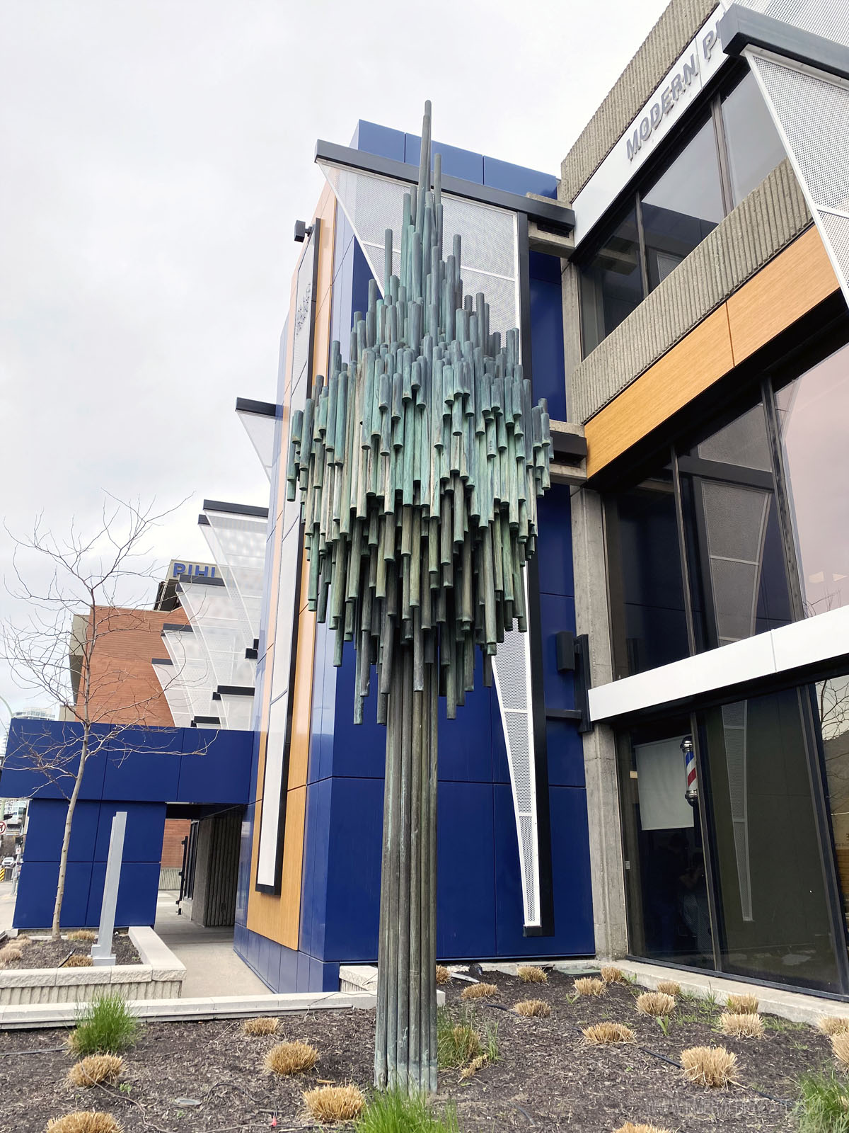 modern public art sculpture that looks like a tree made of bars