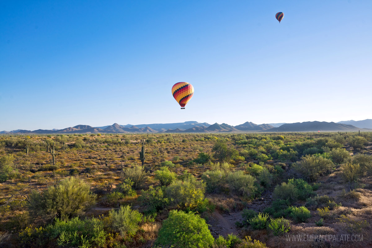 two hot air balloons floating over the desert in Arizona, a must do on your 3 days weekend in Scottsdale