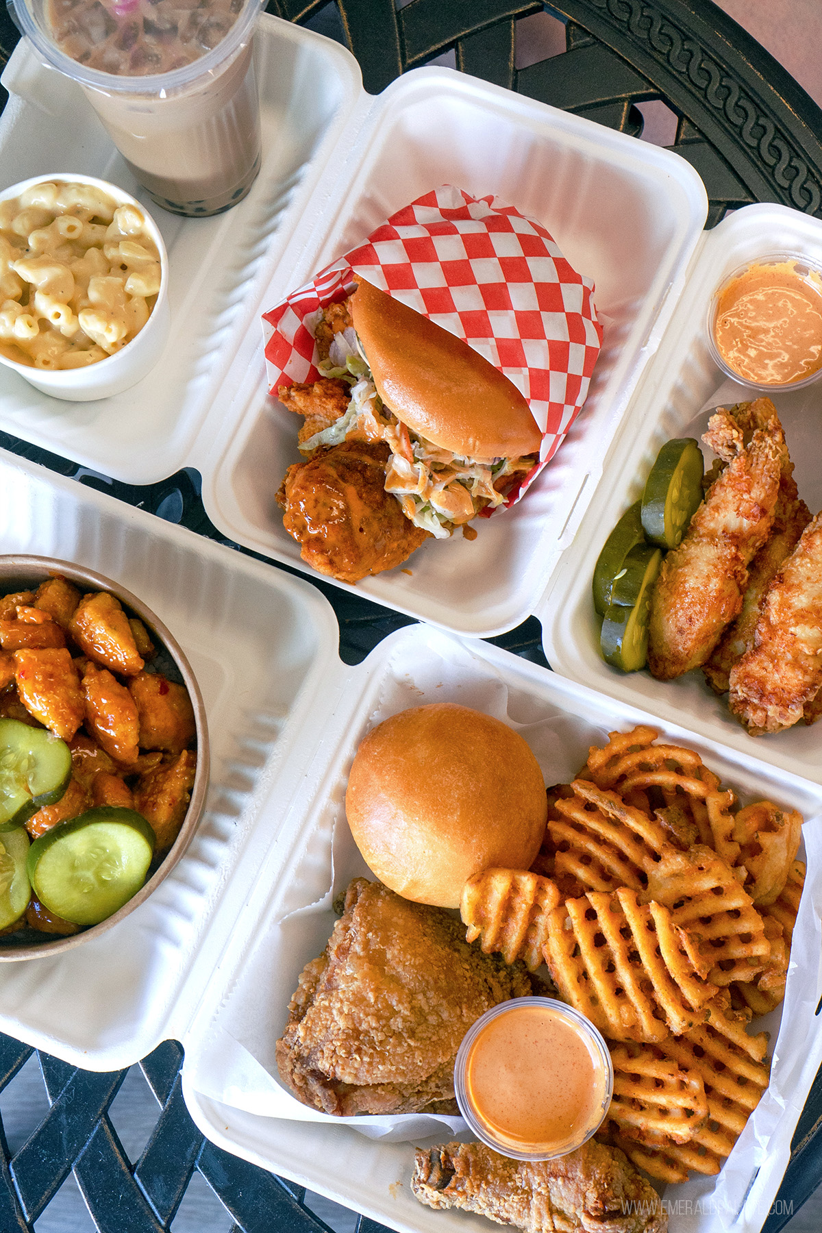 spread of some of the best fried chicken in Seattle, including a sandwich, pieces, chicken bowl, mac and cheese, waffle fries, and boba milk tea
