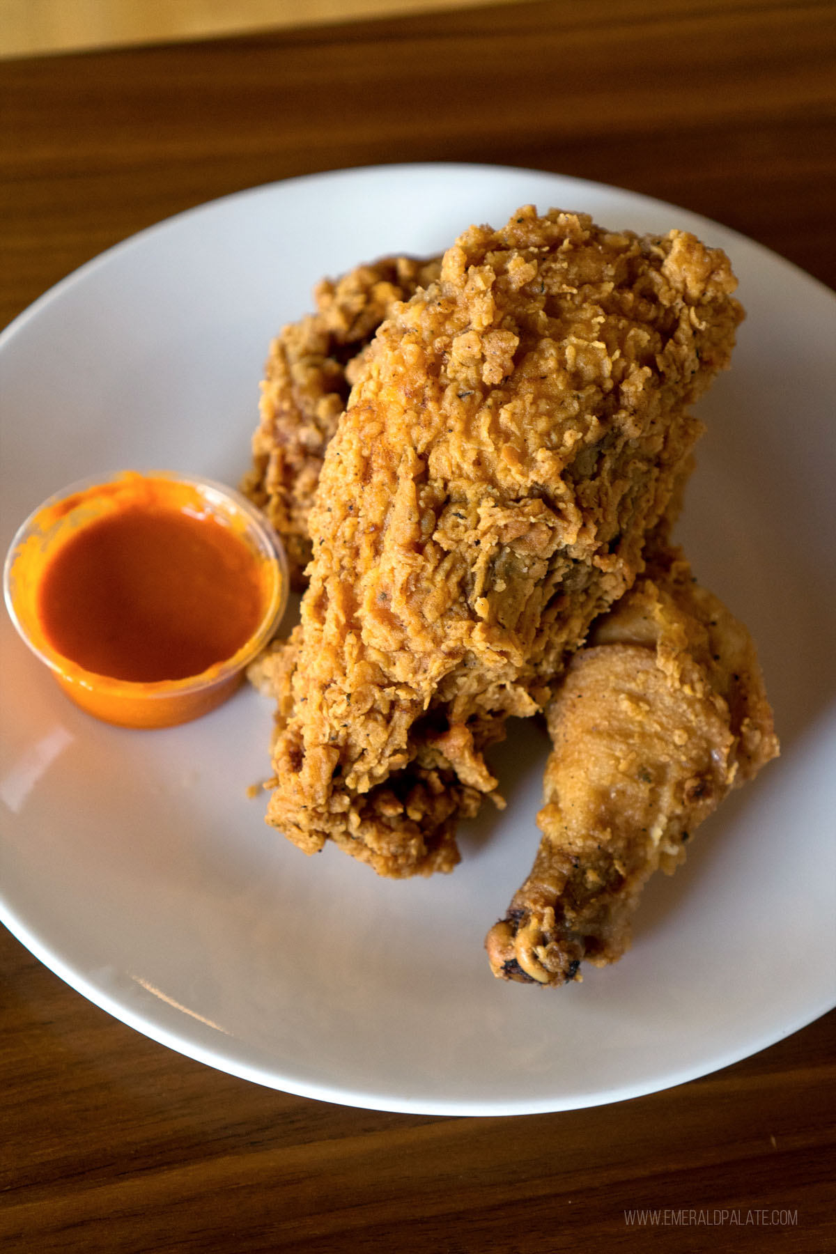 huge fried chicken breast sitting on a fried chicken leg