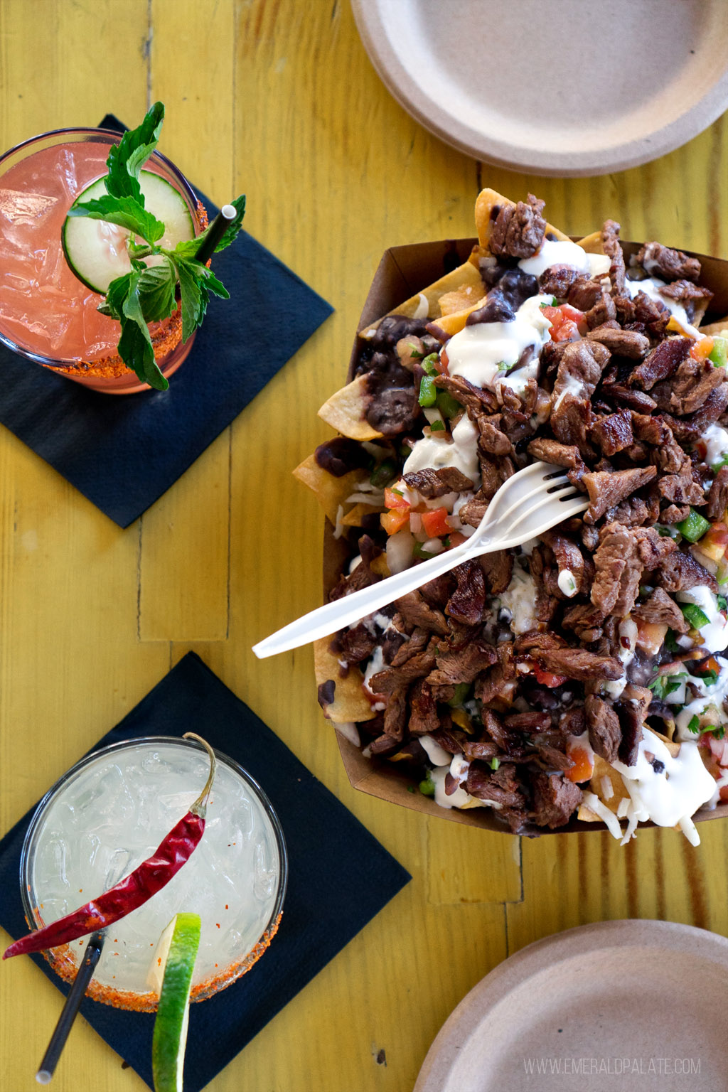 some of the best nachos in Seattle on a table with margaritas at a Mexican restaurant