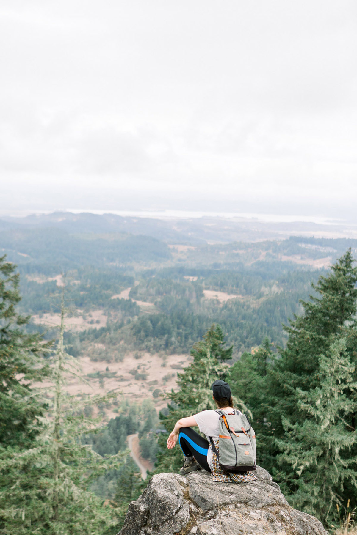 woman sitting at a lookout over Spencer Butte, one of the most fun things to do in Eugene, Oregon