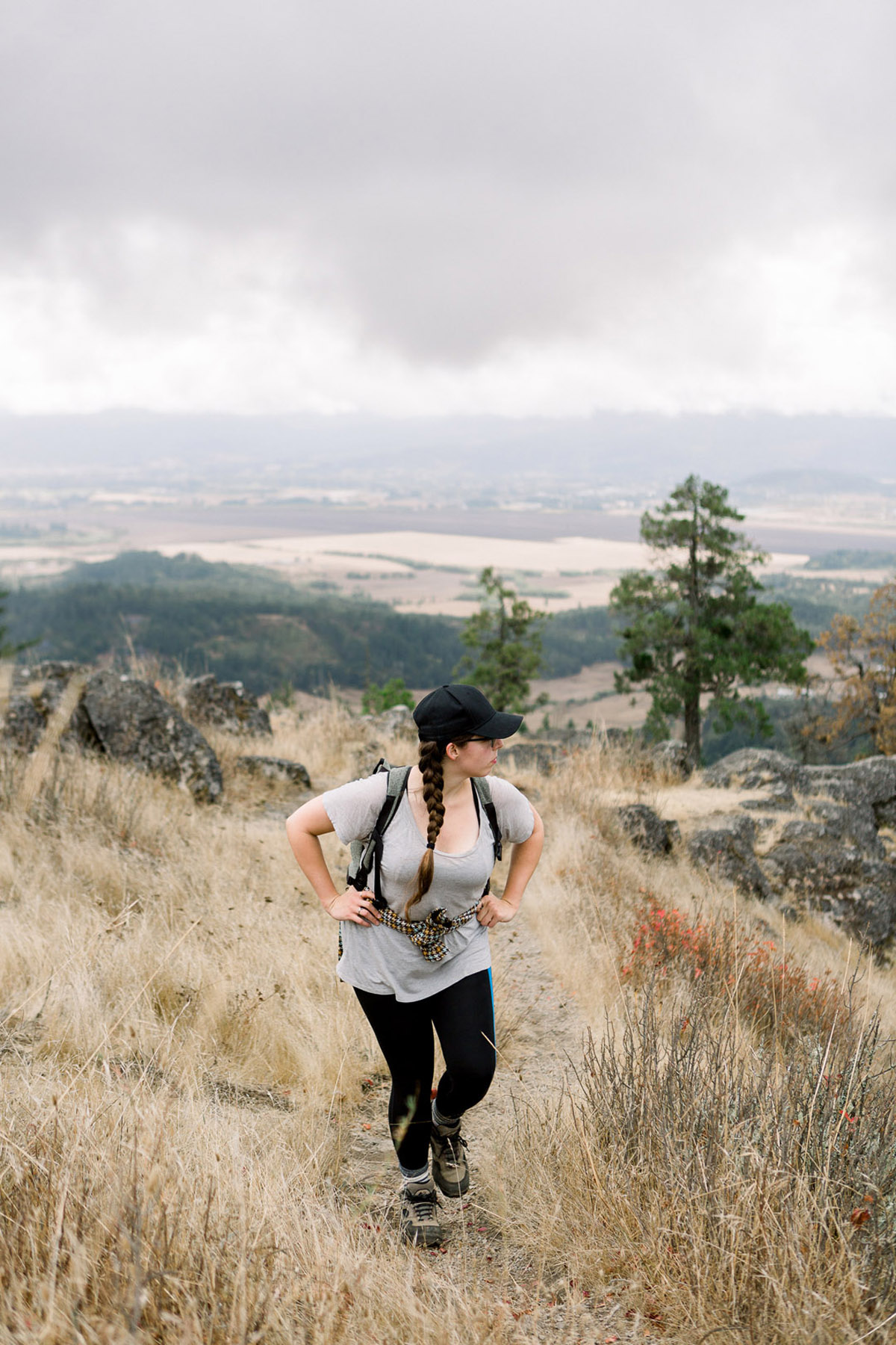 woman hiking in a meadow on Spencer Butte, one of the most fun things to do in Eugene, Oregon
