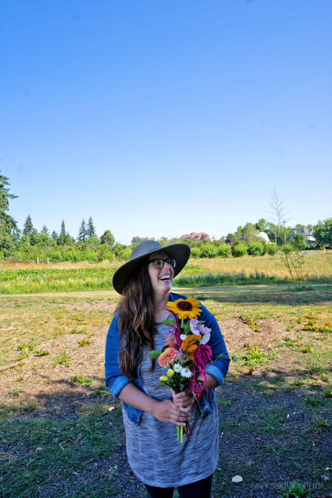 woman laughing holding a bouquet of flowers from a u-pick farm