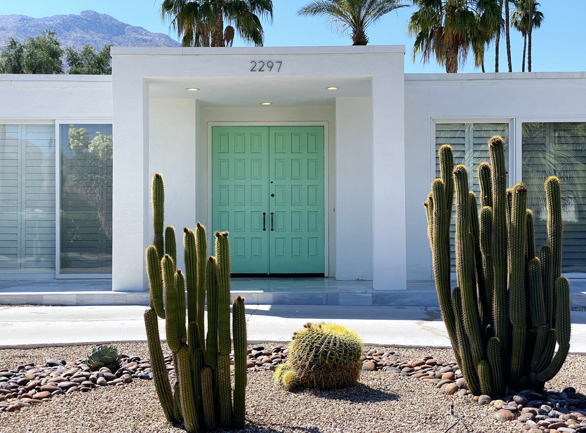 retro mid century modern home with a bright door