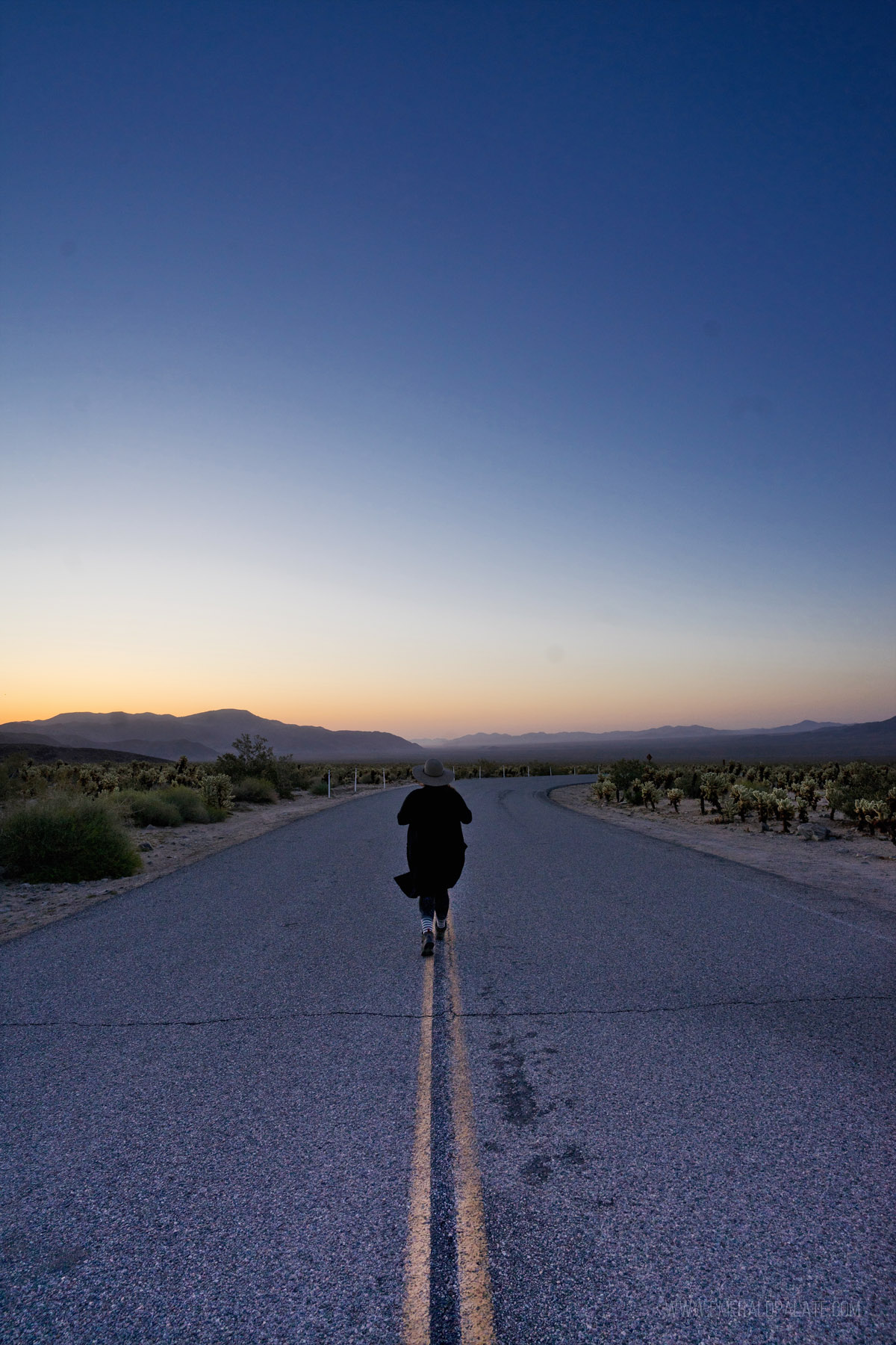 woman running in the road at sunrise