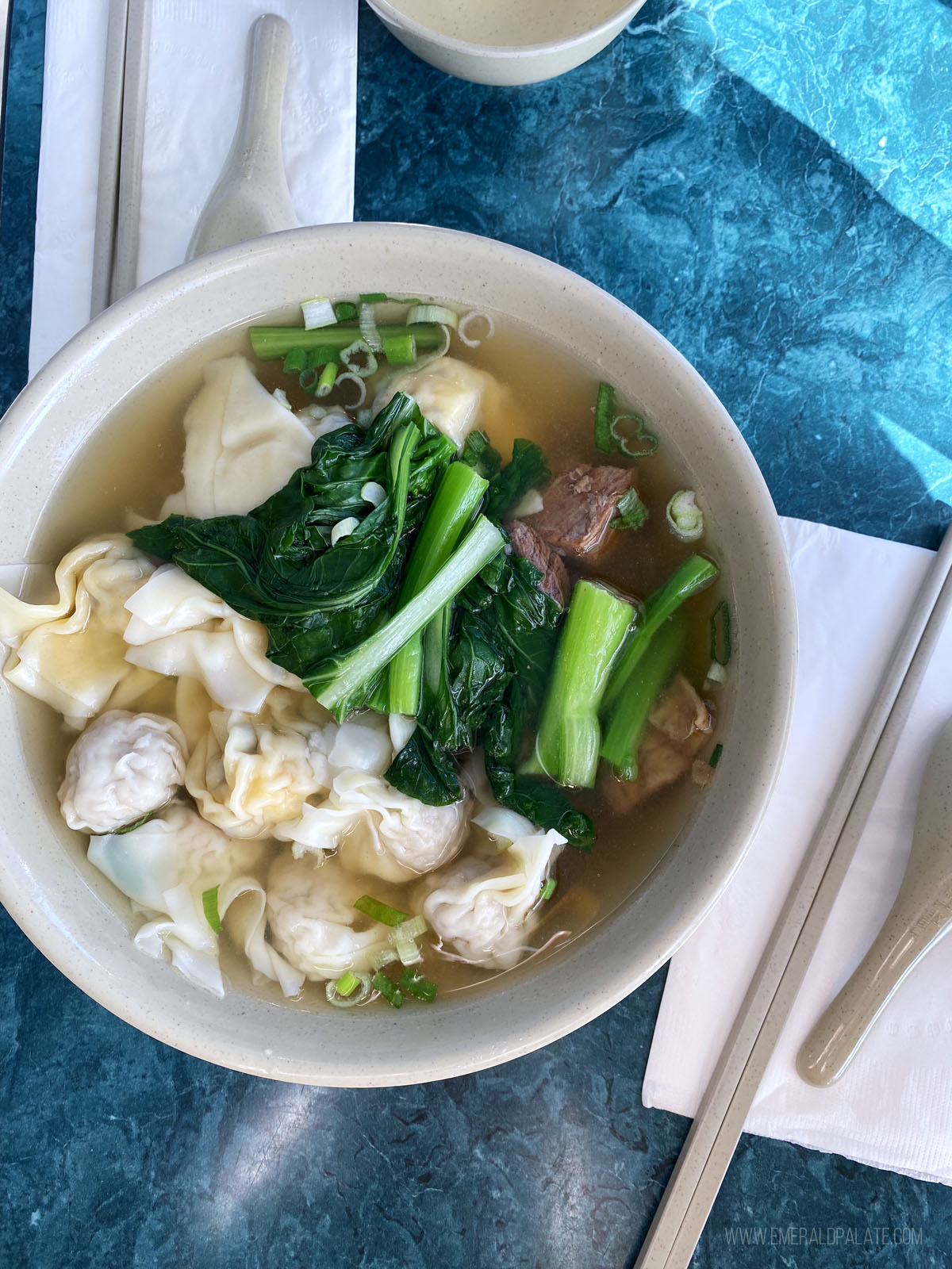 bowl of wonton soup with Chinese broccoli