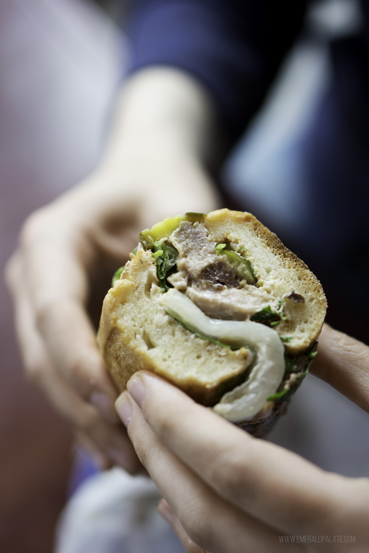 person holding a sandwich from one of the best Seattle lunch spots