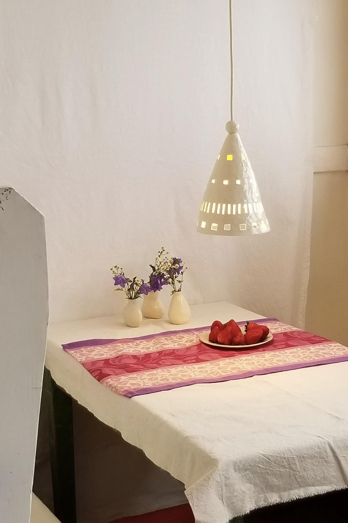 Ceramic pendant light hanging over a table