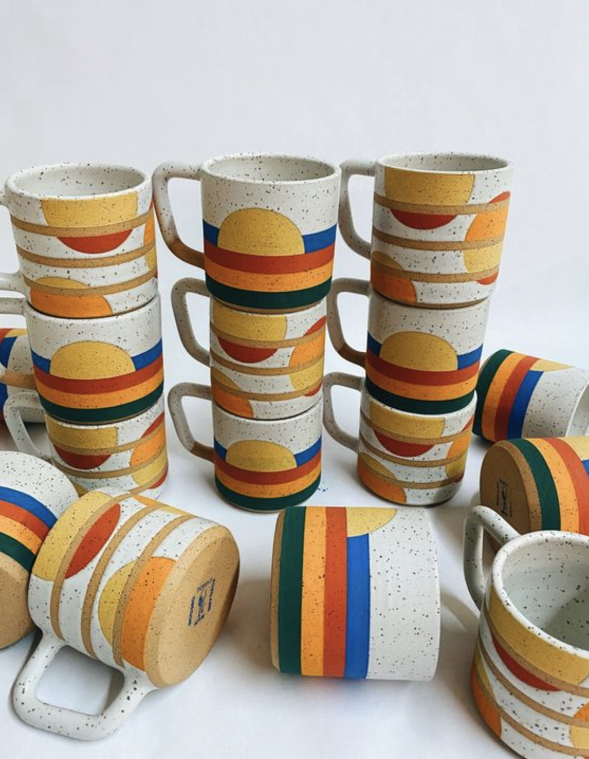 stacks of colorful ceramic mugs
